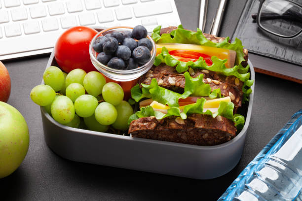 istock Healthy office lunch box with sandwich and fresh vegetables 1307356668