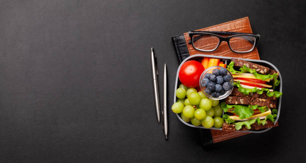 istock Healthy office lunch box with sandwich and fresh vegetables 1307357214