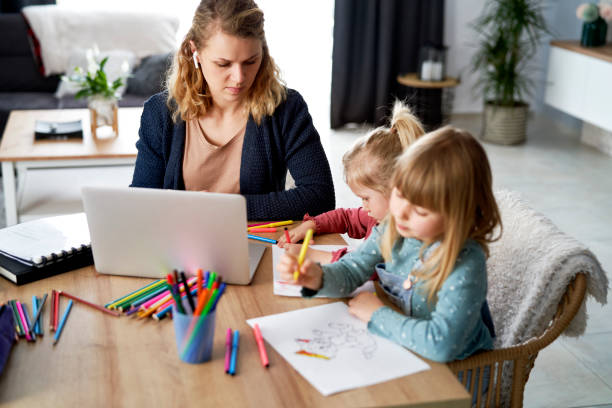 istock Busy mother working at home with her daughters 1307357436