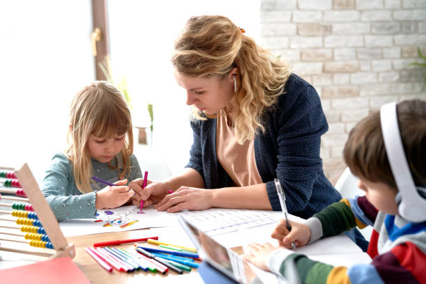 istock Mom helping her kids with homeschooling during the lockdown 1307357511
