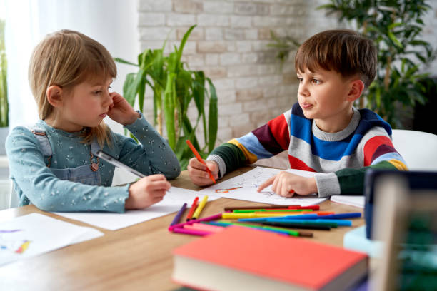 istock Brother and sister doing homework together at home 1307357569