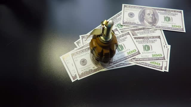 money gun and hand grenade on black background