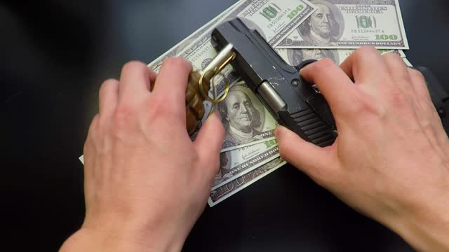 money gun and hand grenade on black background