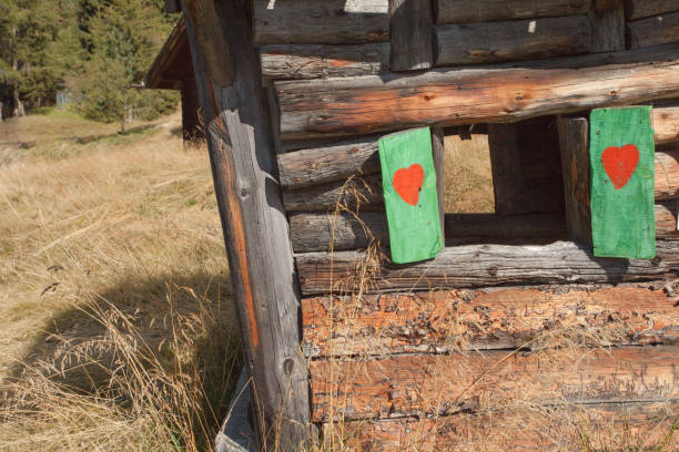 heart shape over a wooden balcony in a small alpine cabine