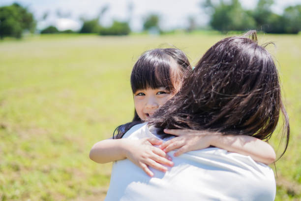 istock Mother holding a small child in her arms 1307361397