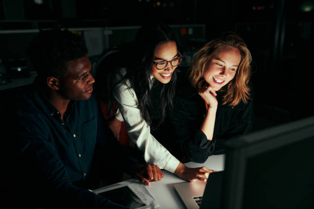 istock Group of happy diversity business people team working on project using laptop late in office at night 1307362439