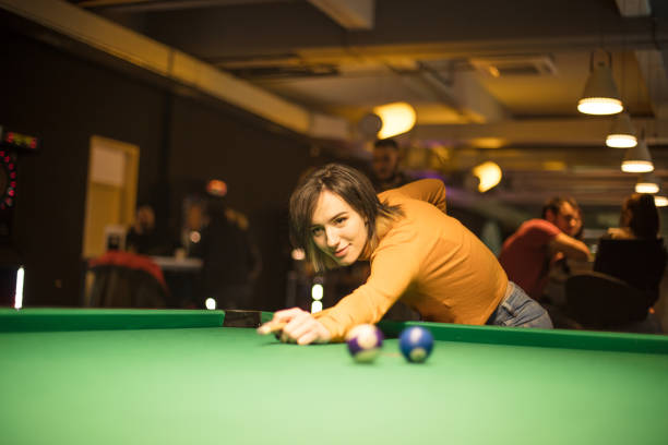 istock Young Woman playing billiard alone. 1307362940