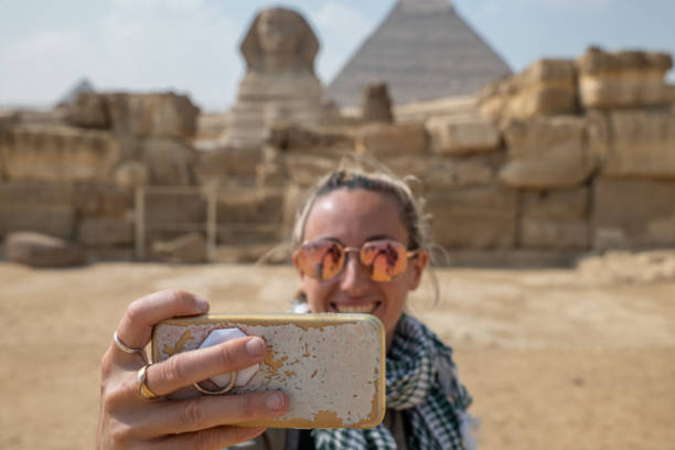 istock Woman takes selfie at the pyramids in Egypt 1307363573