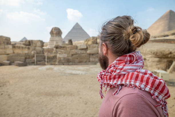 istock Man contemplates wonder of Egypt, Sphinx and pyramids 1307363574