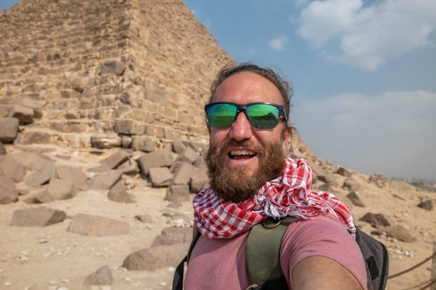 istock Man takes selfie at the pyramids in Egypt 1307363802