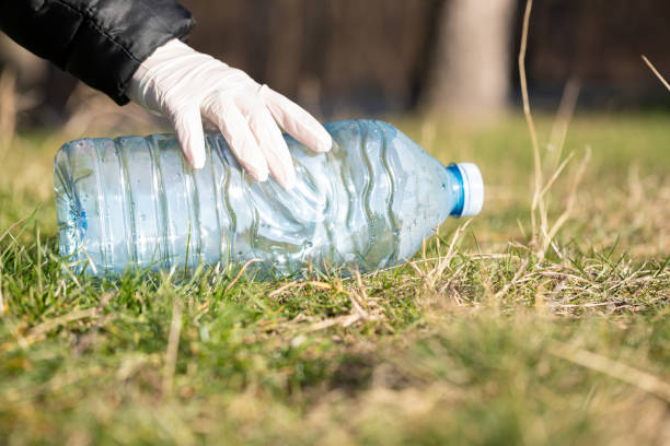 istock Picking up bottle from ground for recycling 1307363871