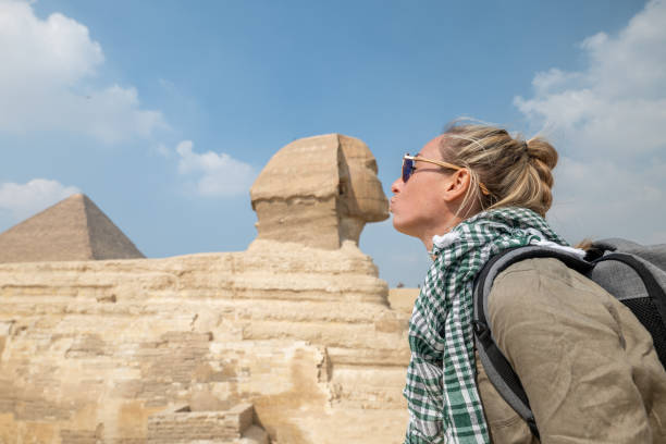 istock Woman kissing the Sphinx in Cairo 1307363878