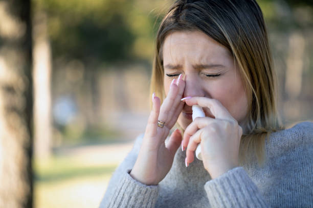istock Sneezing and taking nasal spray in nature 1307363974