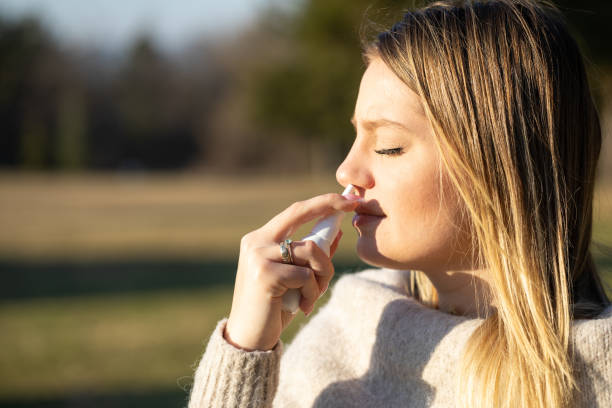 istock Taking nose drops because of pollen allergy 1307364119