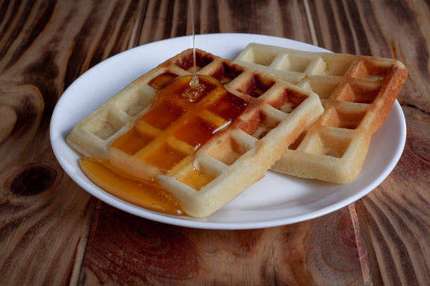 istock Honey pouring from dipper on Belgian waffles 1307364239