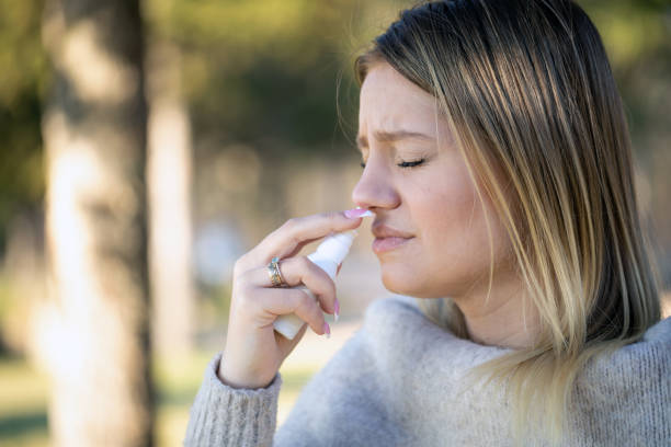 istock Taking nose drops because of pollen allergy 1307364440
