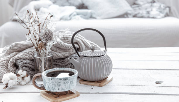 istock Cozy Scandinavian composition with teapot, ceramic cup of tea and decor details copy space. 1307365294