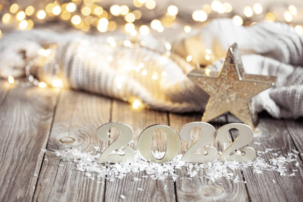 istock Cozy festive composition with the numbers 2022 and decor details close up. 1307365380