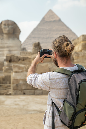 View of a male tourist enjoying a tour to the Pyramids of Giza in Egypt.