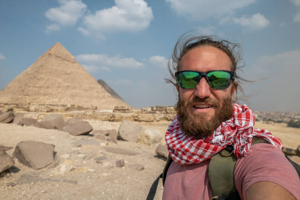 istock Man takes selfie at the pyramids in Egypt 1307365869