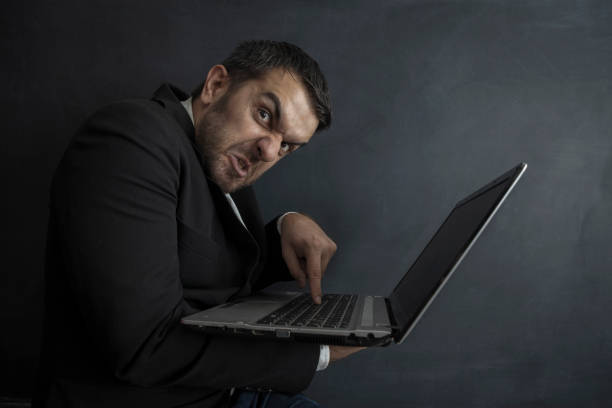istock Furious Businessman with laptop 1307365885