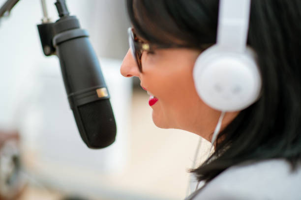 istock Close-up of podcaster behind microphone 1307366165