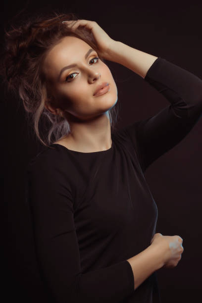 istock Pretty young brunette model posing in the shadows 1307366923