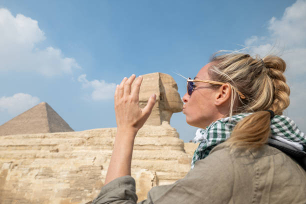 istock Woman kissing the Sphinx in Cairo, Egypt 1307367008