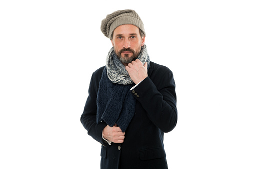 mature man feeling cold in winter. chill outside. winter weather forecast. man wear warm clothes. bearded man in knitted hat and scarf. winter fashion accessory. male isolated on white.