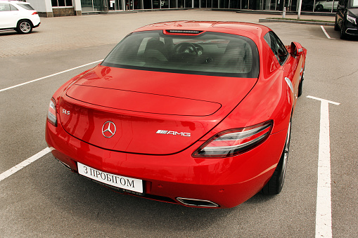 A gray colored second generation Mercedes SLK 200 is parked in a parking lot in Glasgow, Scotland on an overcast day.