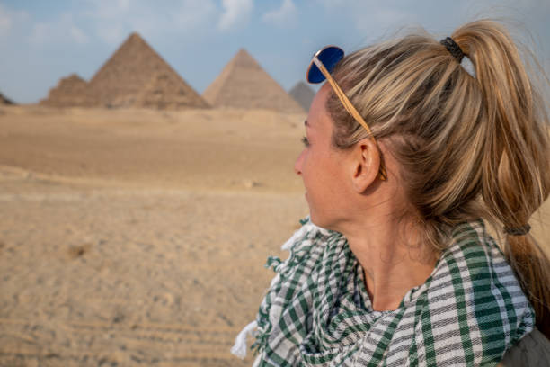 istock Woman contemplates the Giza Pyramids 1307367977