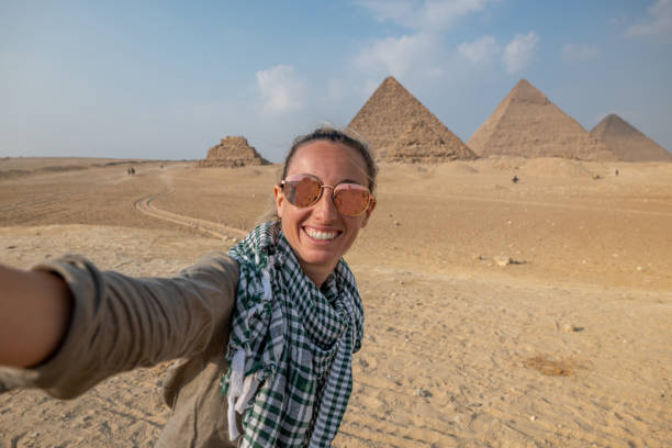 istock Woman takes selfie at the pyramids in Egypt 1307368528
