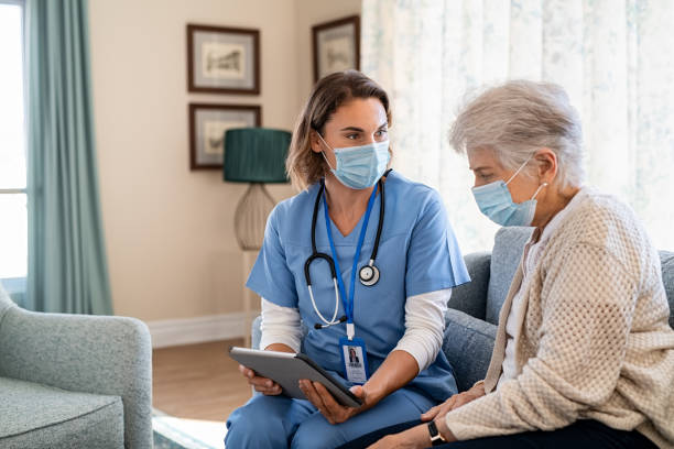 istock Nurse explaining therapy to senior woman at home visit 1307369094