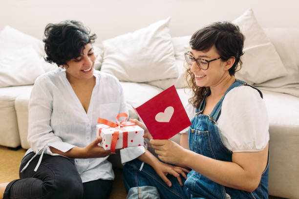 istock Lesbian couple with gift and valentines card 1307370019
