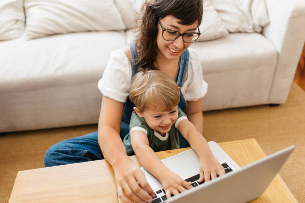 istock Smiling woman and son with laptop 1307370271