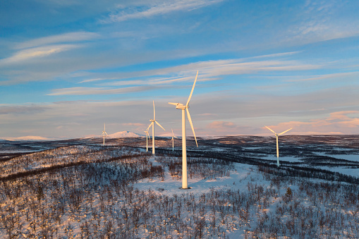 Wind power stations in a winter landscape in the Lapland province in north of Sweden above the polar circle.