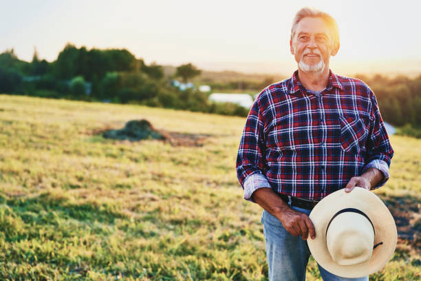 Proud senior man looks over his land