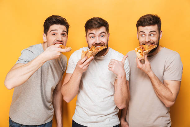 istock Three young happy men eating pizza 1307373928