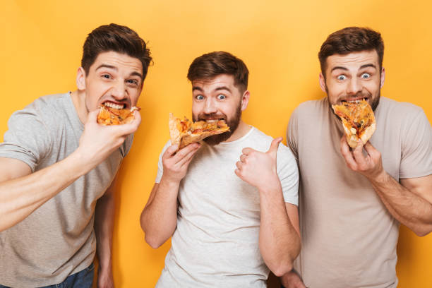 istock Three young satisfied men eating pizza 1307374408