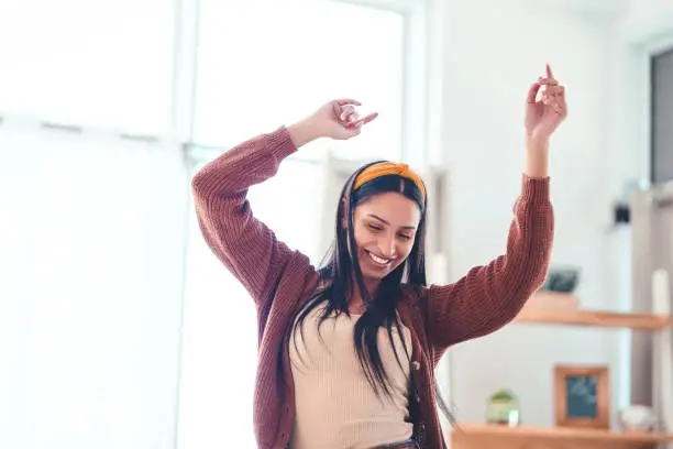 Shot of a young woman in the living room at home