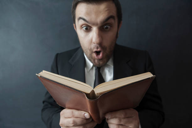istock Funny Businessman with book 1307374640