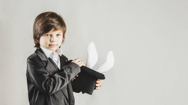 istock Young magician hiding a toy bunny in his top hat 1307374812