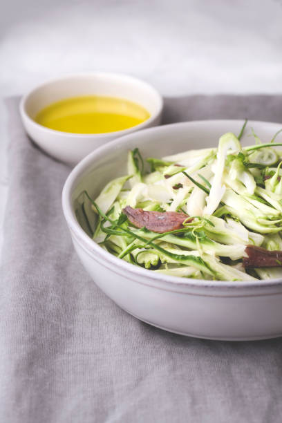 Puntarelle alla romana or asparagus Catalonian chicory salad with anchovy dressing and olive oil, italian food, selective focus, close-up. Italian traditional seasoning recepies Puntarelle alla romana or asparagus Catalonian chicory salad with anchovy dressing and olive oil, italian food, selective focus, close-up. Italian traditional seasoning recepies puntarelle stock pictures, royalty-free photos & images