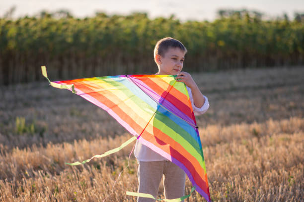 istock Rainbow kite close-up. The boy is about to launch a kite 1307377128