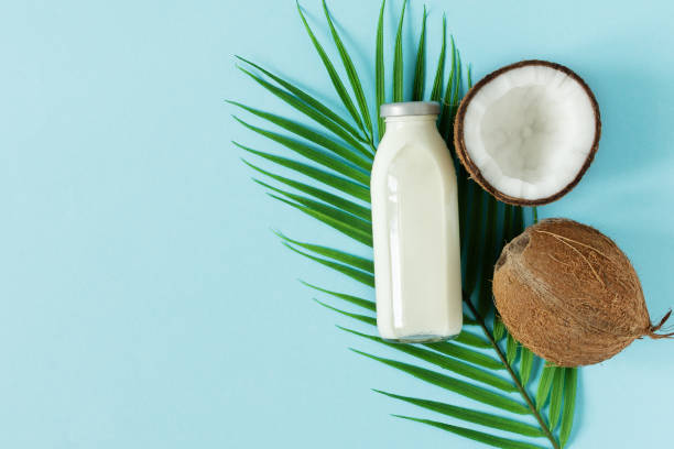 istock Bottle of coconut vegan milk and coconuts top view. 1307378481