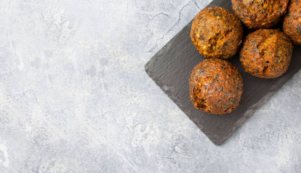 istock Top view of falafel on black slate board on gray surface with copy space 1307379720