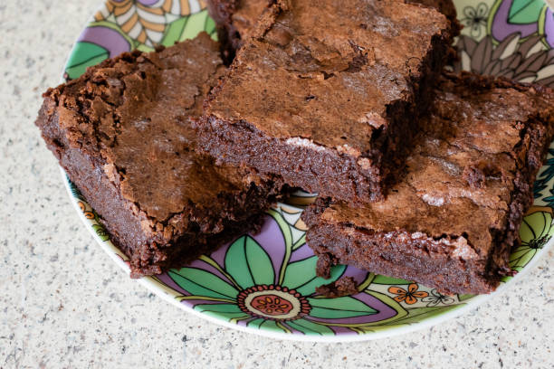 istock Fudgy, gooey chocolate brownies stacked on a brightly colored plate 1307380937