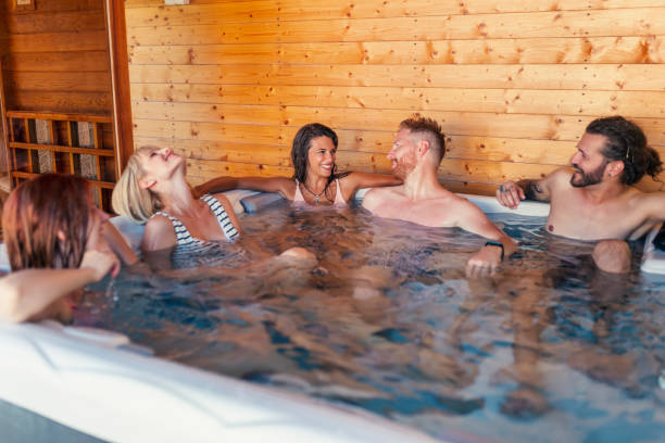 istock Friends relaxing in a hot tub while on a vacation 1307380956
