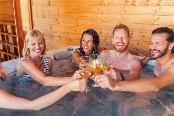 istock Friends relaxing and making a toast in a hot tub while on a vacation 1307380978