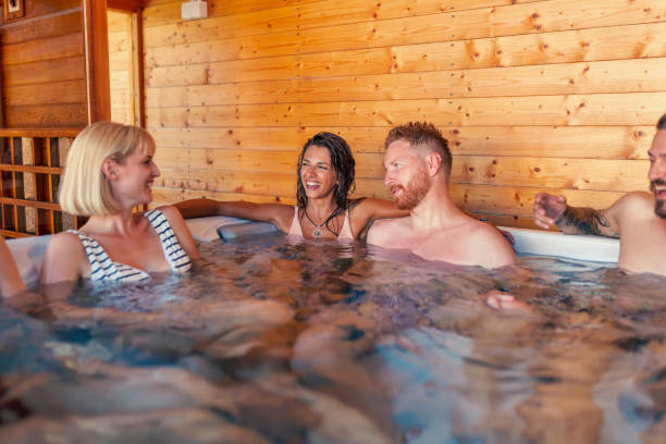 istock Friends relaxing and having fun in a hot tub while on a vacation 1307380991